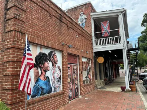A city street in Kennesaw where an American flag - and a Confederate flag - are displayed